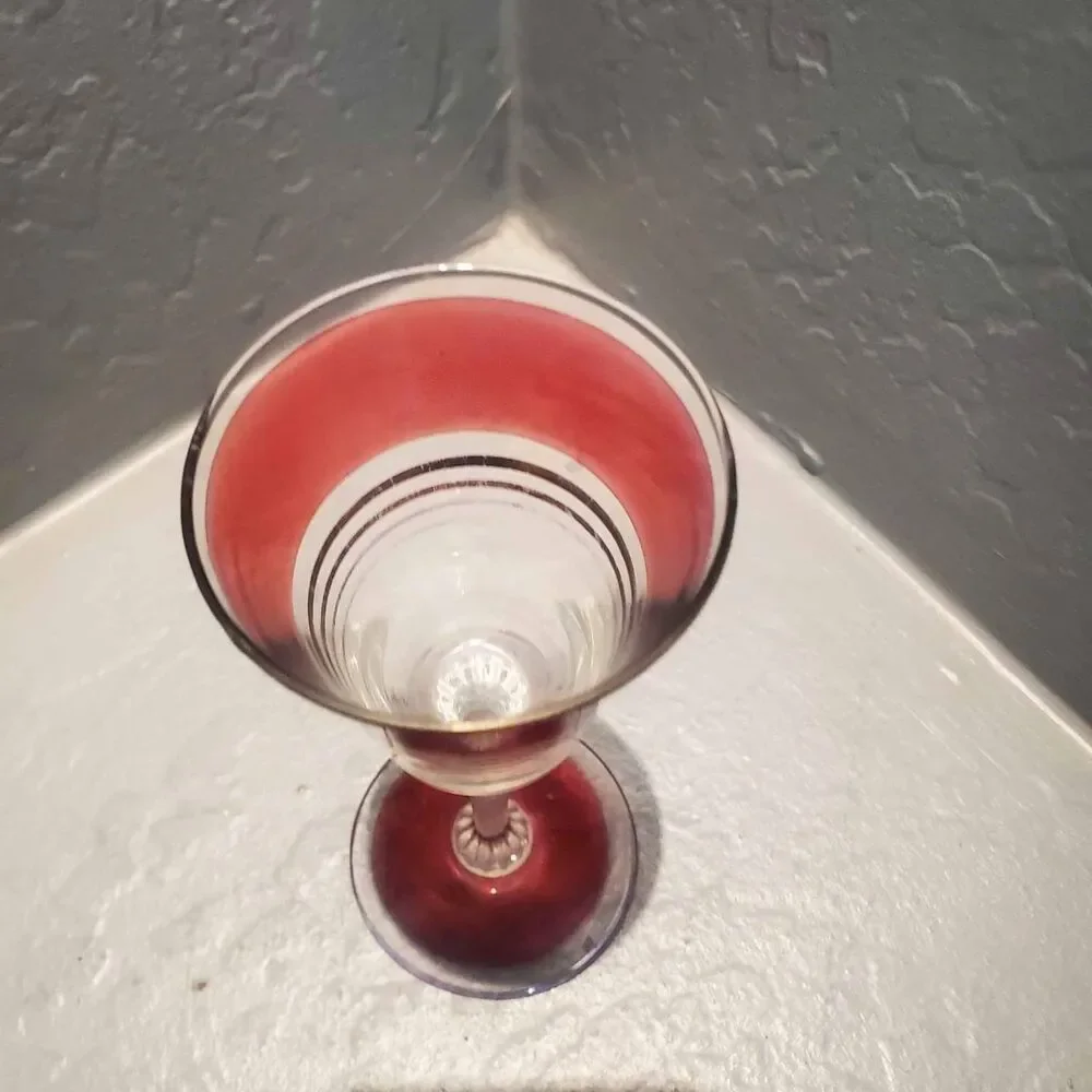 1 red and gold champagne glass